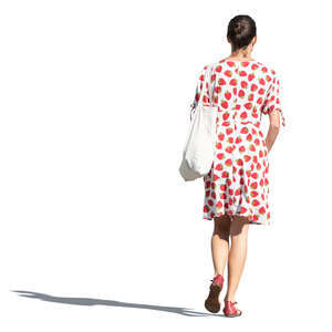 cut out woman in a strawberry patterned summer dress walking