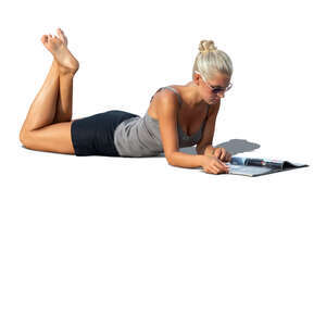 cut out woman lying on the ground and reading a magazine