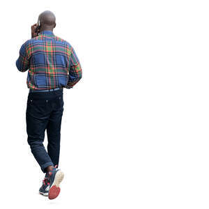 cut out black man walking and talking on a phone