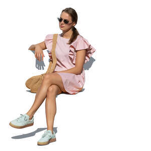 cut out woman in a pink summer dress sitting