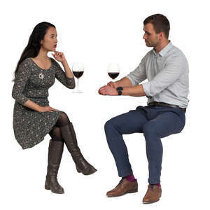 cut out man and woman sitting in a restaurant and drinking wine
