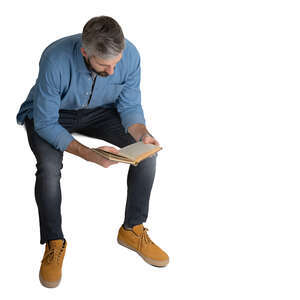 cut out man sitting and reading seen from above