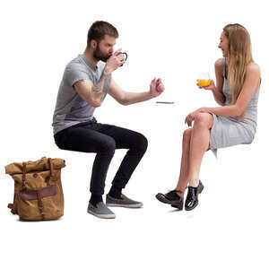 man and woman sitting in a cafe and talking