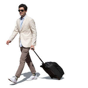 cut out handsome man with a suitcase walking on sunny day