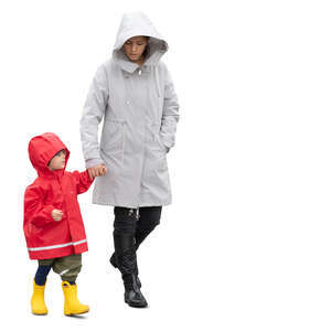 cut out mother and son walking hand in hand on a rainy autumn day