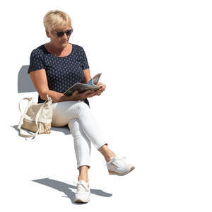cut out older woman sitting and reading a magazine