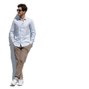 cut out man standing and leaning casually against the wall with hands in his pockets