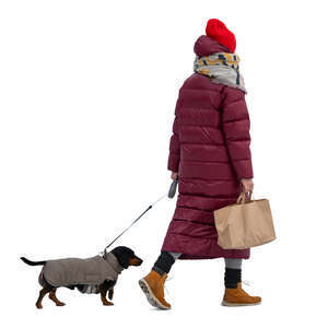 cut out woman in a puffer winter jacket walking a dog