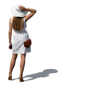 cut out woman in a white summer dress and hat standing