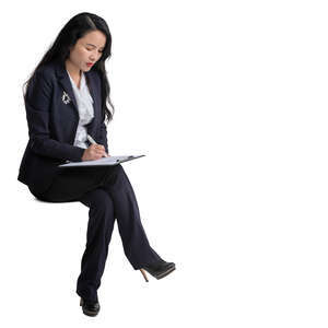 cut out asian businesswoman sitting and taking notes