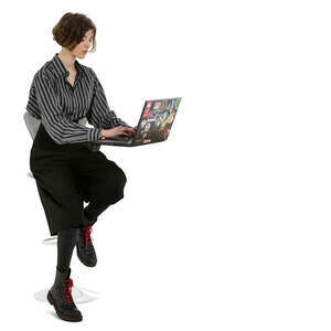 cut out young woman working with laptop sitting at a bar counter