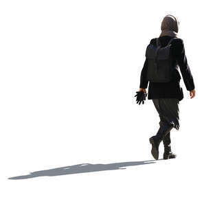 cut out backlit woman wearing an autumn overcoat walking