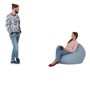 cut out woman sitting in a bean bag talking to a man standing next to her
