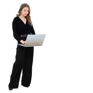 cut out woman in a black costume standing by a desk and working with a laptop