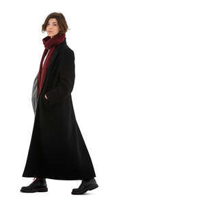 cut out young woman in a long black overcoat walking