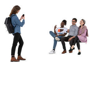 cut out young woman taking a picture of her three friend sitting on a bench