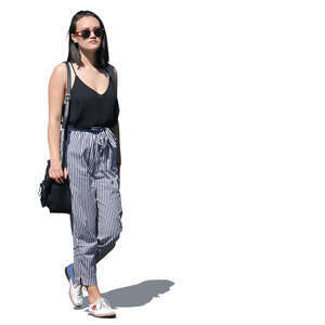 asian woman in striped pants walking
