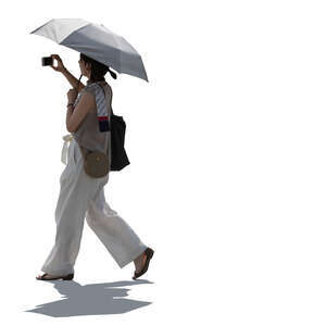 backlit woman with parasol walking