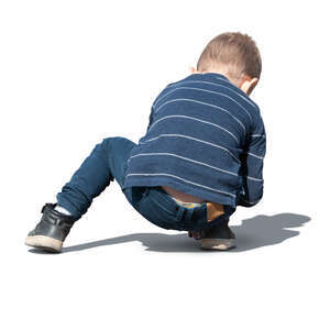 little boy playing on the ground