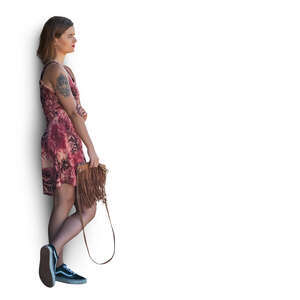 cut out woman in a summer dress leaning against the wall