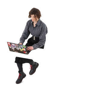 cut out woman sitting at a table and working with laptop seen from above