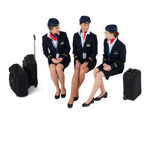three cut out flight crew members sitting and talking