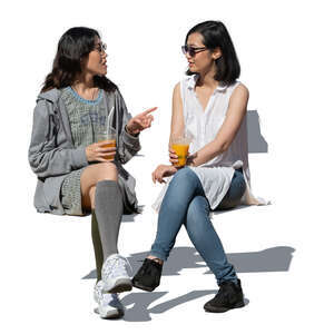 two cut out young asian women sitting and talking