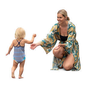 cut out woman with her baby daughter playing by the pool