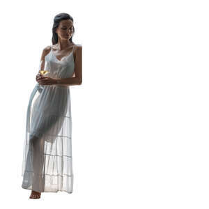 cut out backlit woman in a white dress leaning against the door and drinking wine