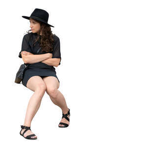 cut out woman in a black dress wearing black hat sitting