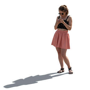 cut out backlit woman standing and texting