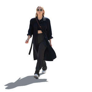 cut out backlit woman in a light black overcoat walking