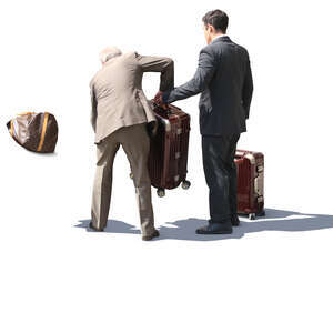 hotel porter and taxi driver loading bags in the trunk