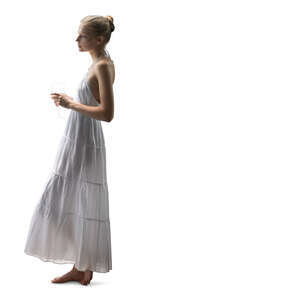 cut out woman in a white dress standing byt the window and drinking wine