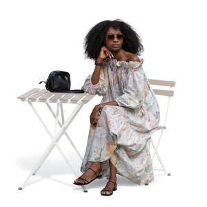 cut out woman in a summer dress sitting at the table