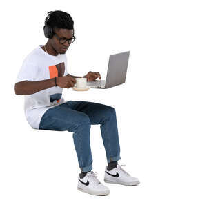 cut out man sitting at a cafe with laptop and headphones