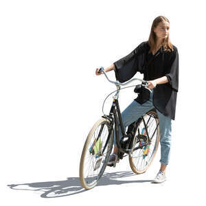 cut out sidelit young woman with a bike standing