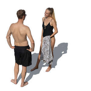 top view of a man and woman at the beach stanfig and talking