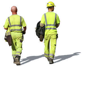 two workmen in work clothes walking in the sunlight
