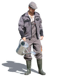 man standing in a garden and watering plants