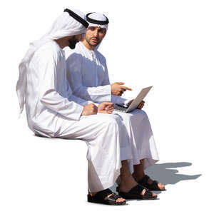 two emirati men sitting and talking