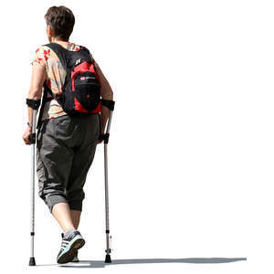 older woman walking with crutches