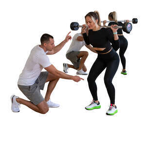 cut out personal trainer instructing a woman in gym
