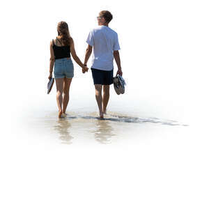 cut out man and woman walking hand in hand barefoot on the beach