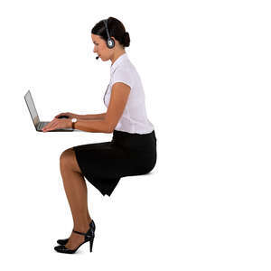 cut out businesswoman with a headset sitting at a desk