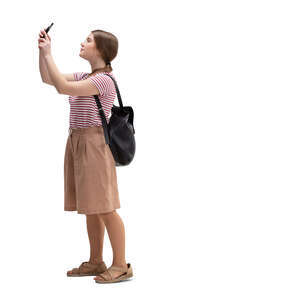 cut out teenage girl standing and taking a picture with her phone