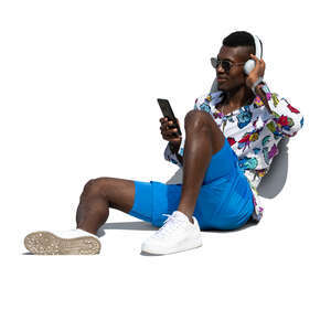 cut out man sitting on the ground and listening to music