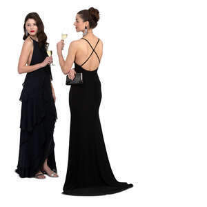 two cut out women in evening dresses standing and drinking champagne