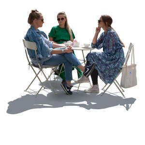 cut out group of backlit women sitting in a street cafe