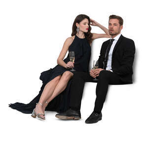 cut out man and woman sitting on a sofa and drinking champagne